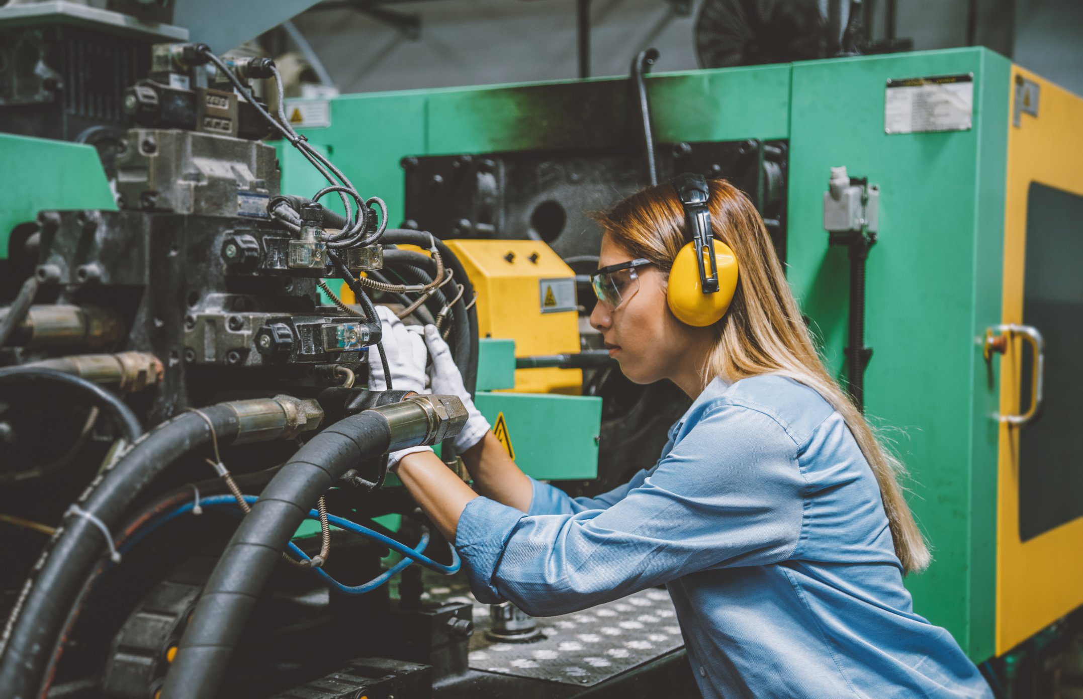 Professional technical worker woman working with production line machine Everything Employers Should Know About Hiring STEM OPT Employees