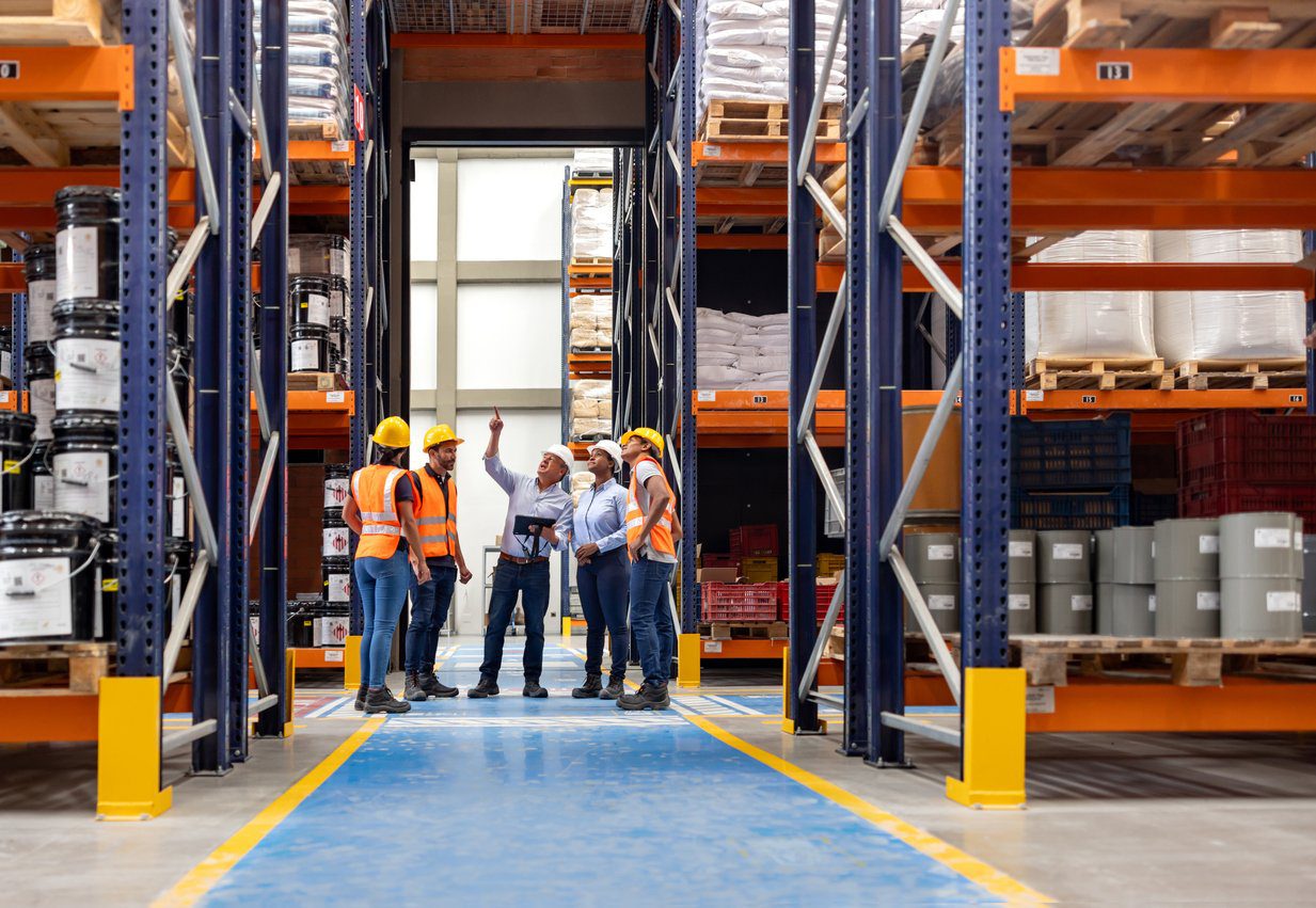 Forperson talking to a group of employees in a meeting at a distribution warehouse Lateral Moves -Yes, They are Important in Every Career